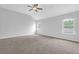 Spacious main bedroom featuring vaulted ceilings, fan, and large windows at 3699 Broadwick Ln, Lithonia, GA 30038