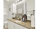 Bright bathroom featuring granite countertops, white cabinets, and modern fixtures at 4845 Willow St, Acworth, GA 30101