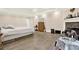 Spacious bedroom with wood-look flooring, tray ceiling, fireplace, and sitting area at 4845 Willow St, Acworth, GA 30101