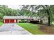 Charming ranch-style home with red garage doors and lush greenery at 4845 Willow St, Acworth, GA 30101