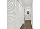 Hallway with closet featuring white shutter doors and hardwood flooring at 4845 Willow St, Acworth, GA 30101