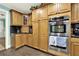 Elegant kitchen showcases stainless steel double oven, granite counters, and custom cabinetry at 4845 Willow St, Acworth, GA 30101