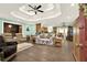 Open-concept living room with hardwood floors and tray ceiling at 4845 Willow St, Acworth, GA 30101