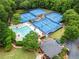 Aerial view of a community clubhouse featuring tennis courts and a pool at 600 Delphinium Nw Blvd, Acworth, GA 30102
