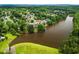 Aerial view of a neighborhood featuring a lake and tree-lined streets at 600 Delphinium Nw Blvd, Acworth, GA 30102