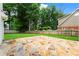 View of the backyard featuring a stone patio, grassy lawn, and a wood fence at 600 Delphinium Nw Blvd, Acworth, GA 30102