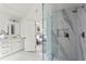 Elegant white bathroom featuring a glass-enclosed shower with marble surround and view into a bedroom at 600 Delphinium Nw Blvd, Acworth, GA 30102