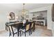 An elegant dining room with modern chandelier, table set for six, and adjacent open-concept kitchen at 600 Delphinium Nw Blvd, Acworth, GA 30102