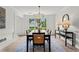 Bright dining room featuring a modern chandelier, large window view, and stylish decor on a light rug at 600 Delphinium Nw Blvd, Acworth, GA 30102