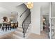 Bright entryway features staircase with iron railing and hardwood floors, adjacent to dining area at 600 Delphinium Nw Blvd, Acworth, GA 30102