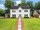 Charming two-story home with landscaped lawn and inviting walkway leading to the front door at 600 Delphinium Nw Blvd, Acworth, GA 30102