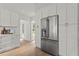 Pristine white cabinets surround stainless steel refrigerator in this bright kitchen space at 600 Delphinium Nw Blvd, Acworth, GA 30102
