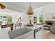 Bright open floorplan kitchen with an island and stone counters flows into the living and dining areas at 600 Delphinium Nw Blvd, Acworth, GA 30102