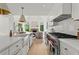 Modern kitchen featuring a large island, stainless steel appliances, and an open view to the living room at 600 Delphinium Nw Blvd, Acworth, GA 30102