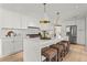 This bright, modern kitchen offers white cabinets, an island with seating, and stainless steel appliances at 600 Delphinium Nw Blvd, Acworth, GA 30102