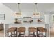 Bright kitchen features a large island, white cabinetry, stone counters, and rattan seating at 600 Delphinium Nw Blvd, Acworth, GA 30102