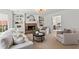 Inviting living room features a stone fireplace, built-in shelving, and comfortable furniture at 600 Delphinium Nw Blvd, Acworth, GA 30102