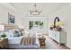 Cozy main bedroom featuring a tufted headboard, sitting area, and lots of natural light at 600 Delphinium Nw Blvd, Acworth, GA 30102