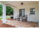 Cozy front porch with stone flooring, seating, and a white door at 600 Delphinium Nw Blvd, Acworth, GA 30102