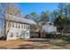 Spacious backyard view of the home with deck, mature trees, and outdoor seating area at 8245 Mill Run Trl, Whitesburg, GA 30185