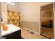 Bright bathroom with a modern sink and view to a bedroom with yellow bedding at 8245 Mill Run Trl, Whitesburg, GA 30185