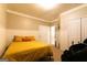 Bedroom with yellow bedding, white wainscoting, and a large massage chair at 8245 Mill Run Trl, Whitesburg, GA 30185