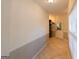 Bright hallway featuring ceramic tile flooring and trim work with access to a closet at 8245 Mill Run Trl, Whitesburg, GA 30185