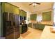 Well-equipped kitchen boasting stainless steel appliances and lots of green cabinets at 8245 Mill Run Trl, Whitesburg, GA 30185