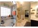 The ensuite bathroom features separate tub and shower, a large window, and plenty of natural light at 8245 Mill Run Trl, Whitesburg, GA 30185