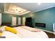 Spacious main bedroom with tray ceiling, dark wood floors and seating area at 8245 Mill Run Trl, Whitesburg, GA 30185