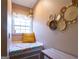 A cozy window seat area features a patterned mattress and a decorative gallery wall at 8245 Mill Run Trl, Whitesburg, GA 30185