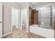 Bright bathroom with a shower and a large bathtub, plus a door leading to the walk in closet at 2366 Proctor Creek Enclave, Acworth, GA 30101