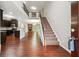 Welcoming foyer featuring hardwood floors, a staircase, and views of the open floor plan at 2366 Proctor Creek Enclave, Acworth, GA 30101