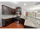 Modern kitchen features granite counters, stainless appliances, and mosaic tile backsplash at 2366 Proctor Creek Enclave, Acworth, GA 30101