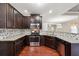 Modern kitchen featuring granite counters, stainless appliances, and mosaic tile backsplash at 2366 Proctor Creek Enclave, Acworth, GA 30101