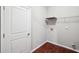 Cozy laundry room with white walls, wire rack, and hardwood floors at 2366 Proctor Creek Enclave, Acworth, GA 30101
