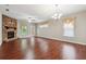 Bright living room features a stone fireplace, hardwood floors, and a modern chandelier at 2366 Proctor Creek Enclave, Acworth, GA 30101