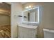 Bright bathroom featuring a modern vanity with marble countertop and a stylish, illuminated mirror at 2436 Green Hollow Ct, Conyers, GA 30012