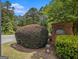 Landscaped community entrance with a brick sign, shrubbery, and trees creating a welcoming and upscale atmosphere at 2436 Green Hollow Ct, Conyers, GA 30012
