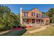 Charming two-story brick home with a welcoming front porch and manicured lawn, perfect for Gathering living at 2436 Green Hollow Ct, Conyers, GA 30012