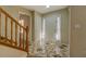Bright foyer showcasing tile flooring, a staircase with wooden railing, and a welcoming entrance at 2436 Green Hollow Ct, Conyers, GA 30012