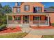 Close-up view of the home's inviting front porch with decorative railings and a well-maintained garden at 2436 Green Hollow Ct, Conyers, GA 30012