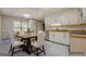 Bright kitchen with white cabinetry, stainless steel appliances and four-seat dining set at 2436 Green Hollow Ct, Conyers, GA 30012