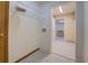 Tiled laundry room with wire shelving and doorway leading to kitchen at 2436 Green Hollow Ct, Conyers, GA 30012