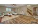 Staged living room with hardwood floors, large windows, and cozy furniture, perfect for relaxation at 2436 Green Hollow Ct, Conyers, GA 30012