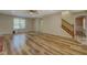 Spacious living room featuring hardwood floors, a ceiling fan, and stairs leading to the upper level at 2436 Green Hollow Ct, Conyers, GA 30012