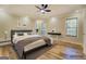 Virtually staged main bedroom featuring a ceiling fan, natural light, and neutral colors at 2436 Green Hollow Ct, Conyers, GA 30012