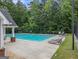 Community pool featuring lounge chairs, a meticulously maintained deck, and mature landscaping providing a resort-like atmosphere at 2436 Green Hollow Ct, Conyers, GA 30012