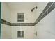 The remodeled shower features a sleek design with white and black tile accents at 2436 Green Hollow Ct, Conyers, GA 30012