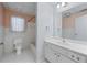 Cozy bathroom with white tiled floors, single sink vanity, large mirror, and shower-tub combo at 3410 Kates Way, Duluth, GA 30097